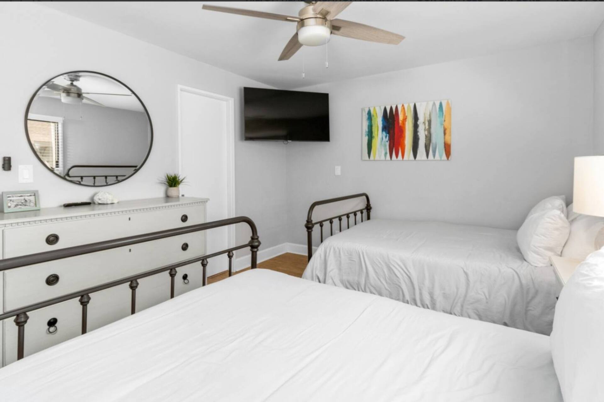 Guest bedroom with two full beds and TV