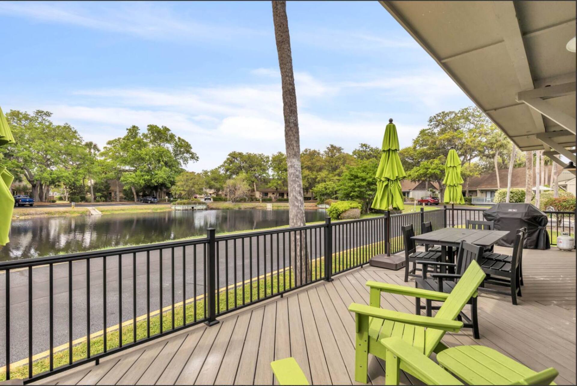 Adirondack chairs on the deck facing the water