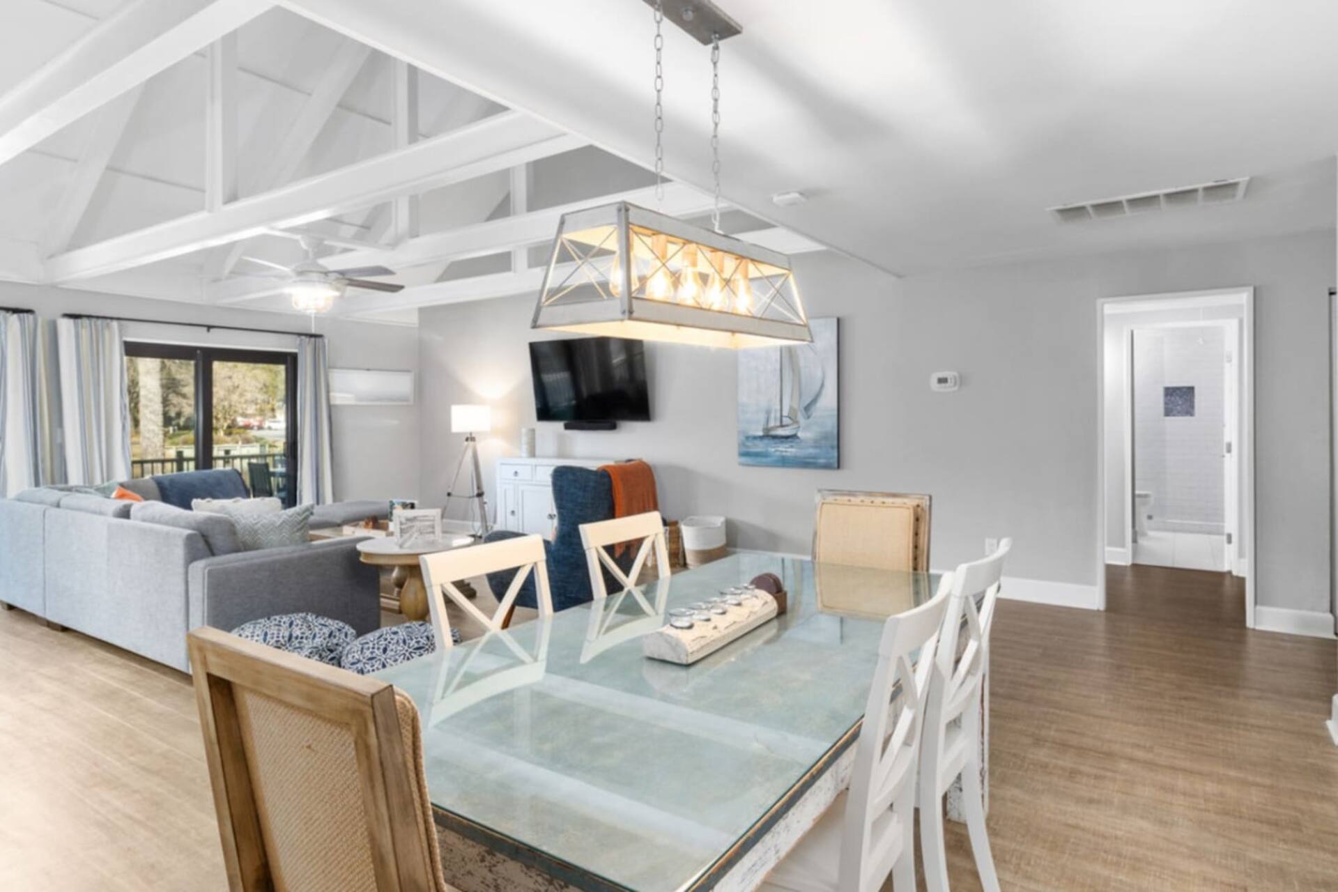 Living and dining area under vaulted ceilings
