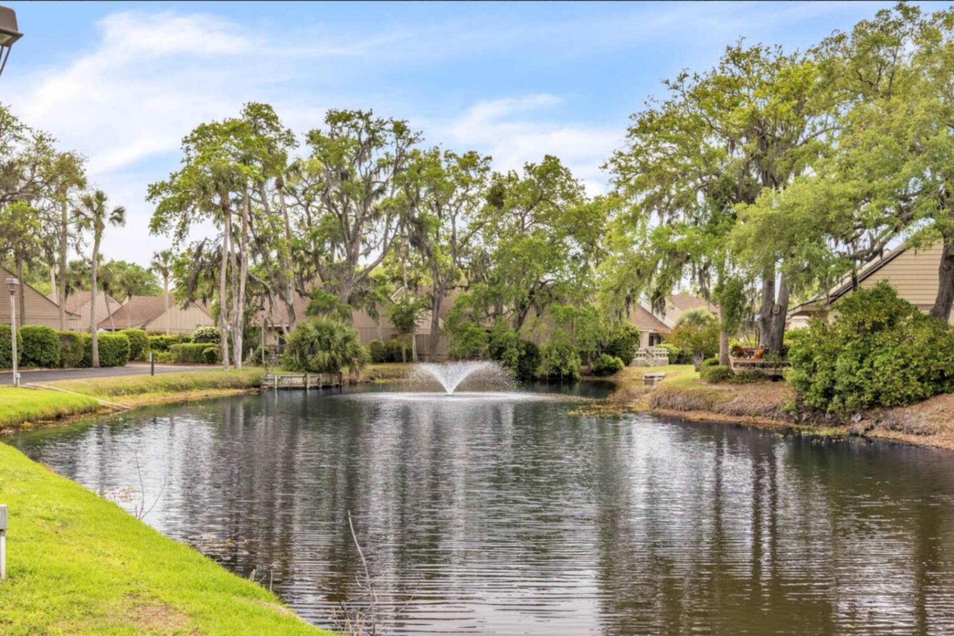Lagoon fountain and live oaks across from the villa